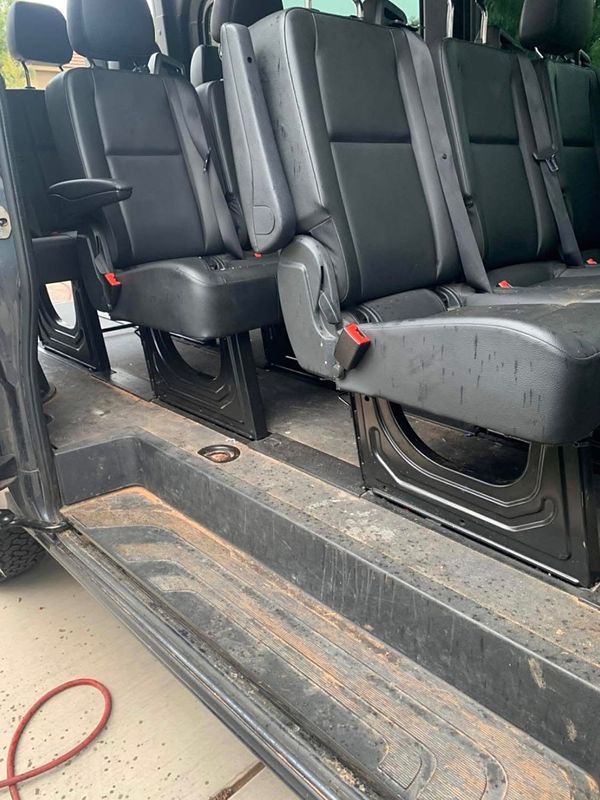 Before: dirt caked on a passenger van's sliding-door step, with spots across the bench seats
