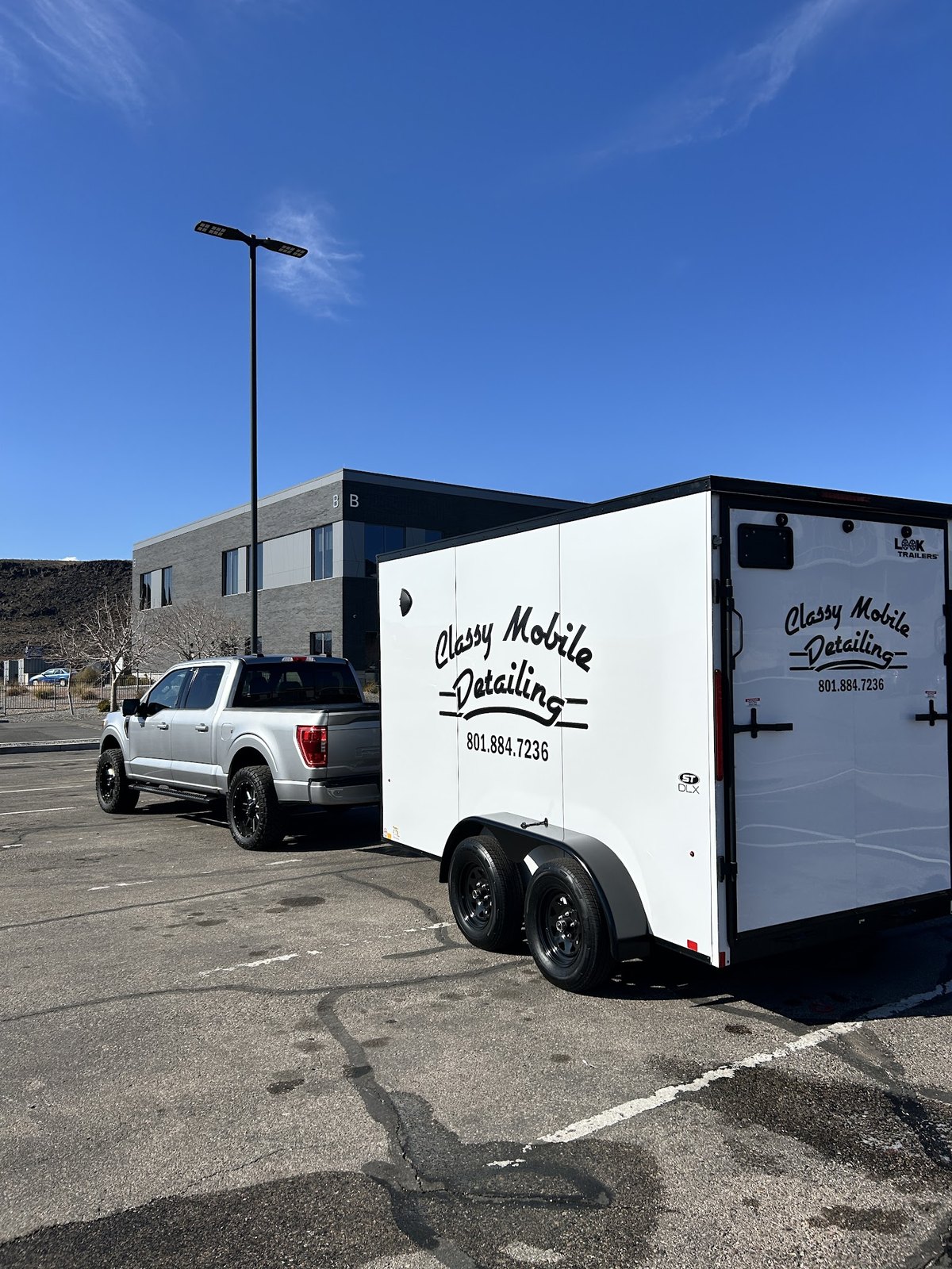 Our enclosed detailing trailer, lettered with the Classy Mobile Detailing script, hitched to the truck and ready for the day's jobs